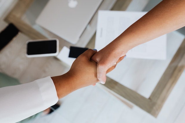 landlord-and-property-manager-shaking-hands-over-desk