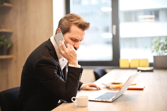 property-manager-on-phone-sitting-at-desj