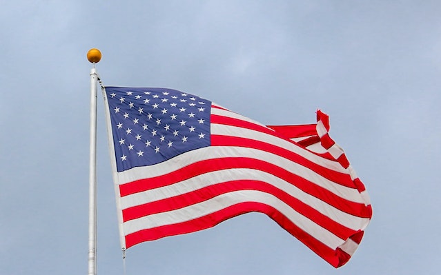 american-flag-waving-in-wind-blue-sky