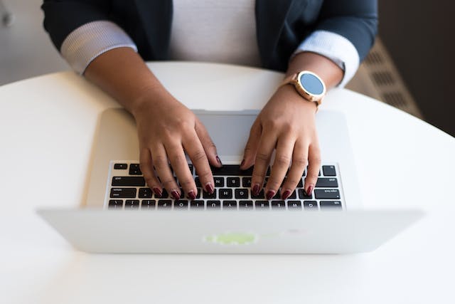 Hands typing on a computer’s keyboard